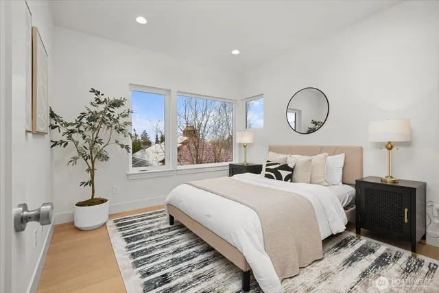 a bedroom with bed and a potted plant