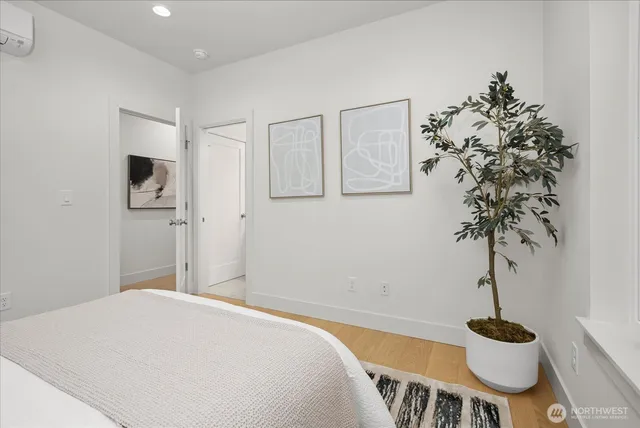 a bedroom with a bed and a potted plant