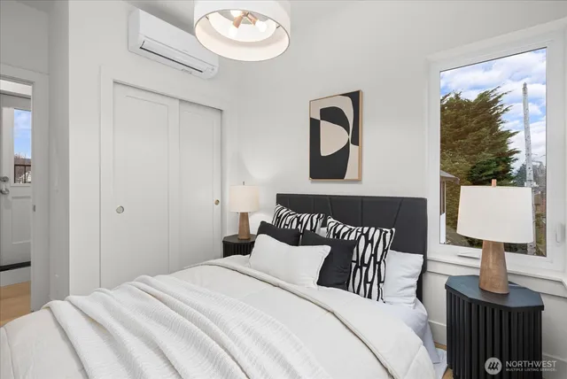 a bedroom with a bed and lamp on table