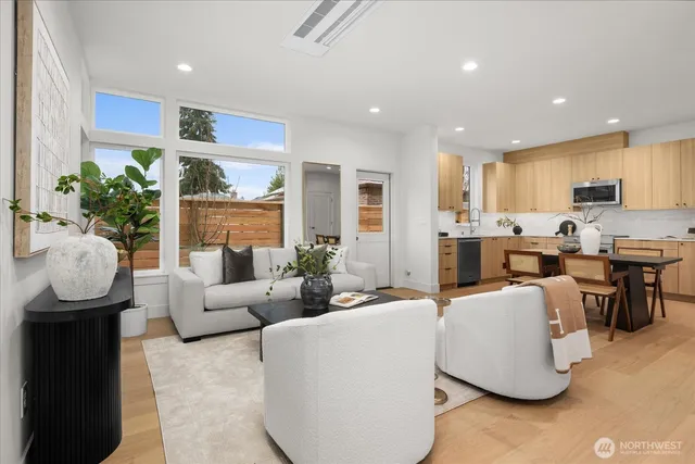 a living room with fireplace furniture and a large window