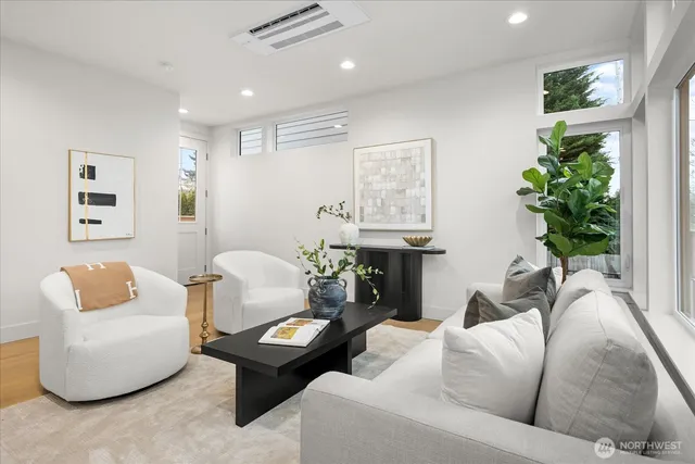 a living room with furniture and a potted plant