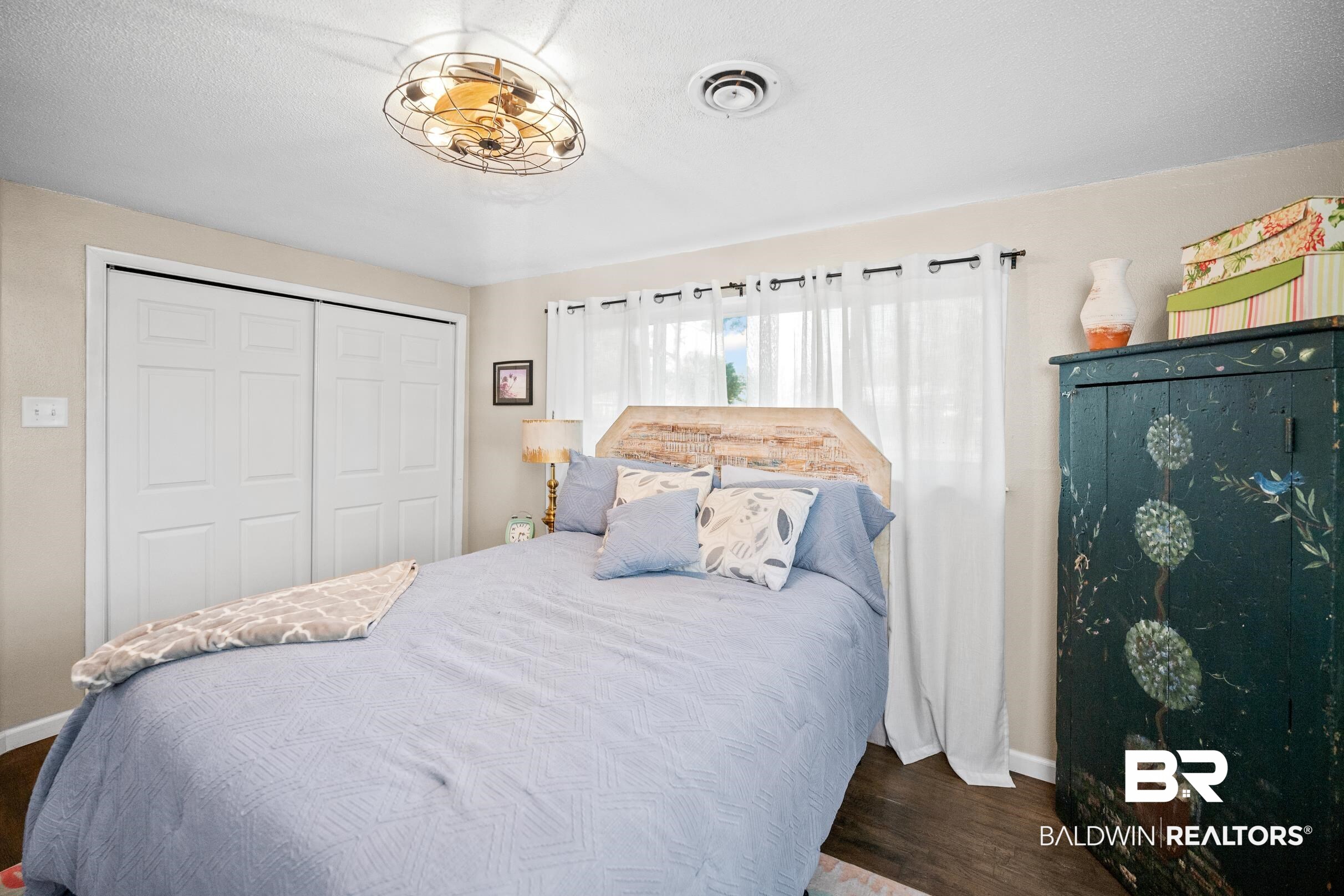 401 West Myrtle Avenue Foley, AL 36535 - Photo 21 of 39 Bedroom with a closet and dark wood-type flooring