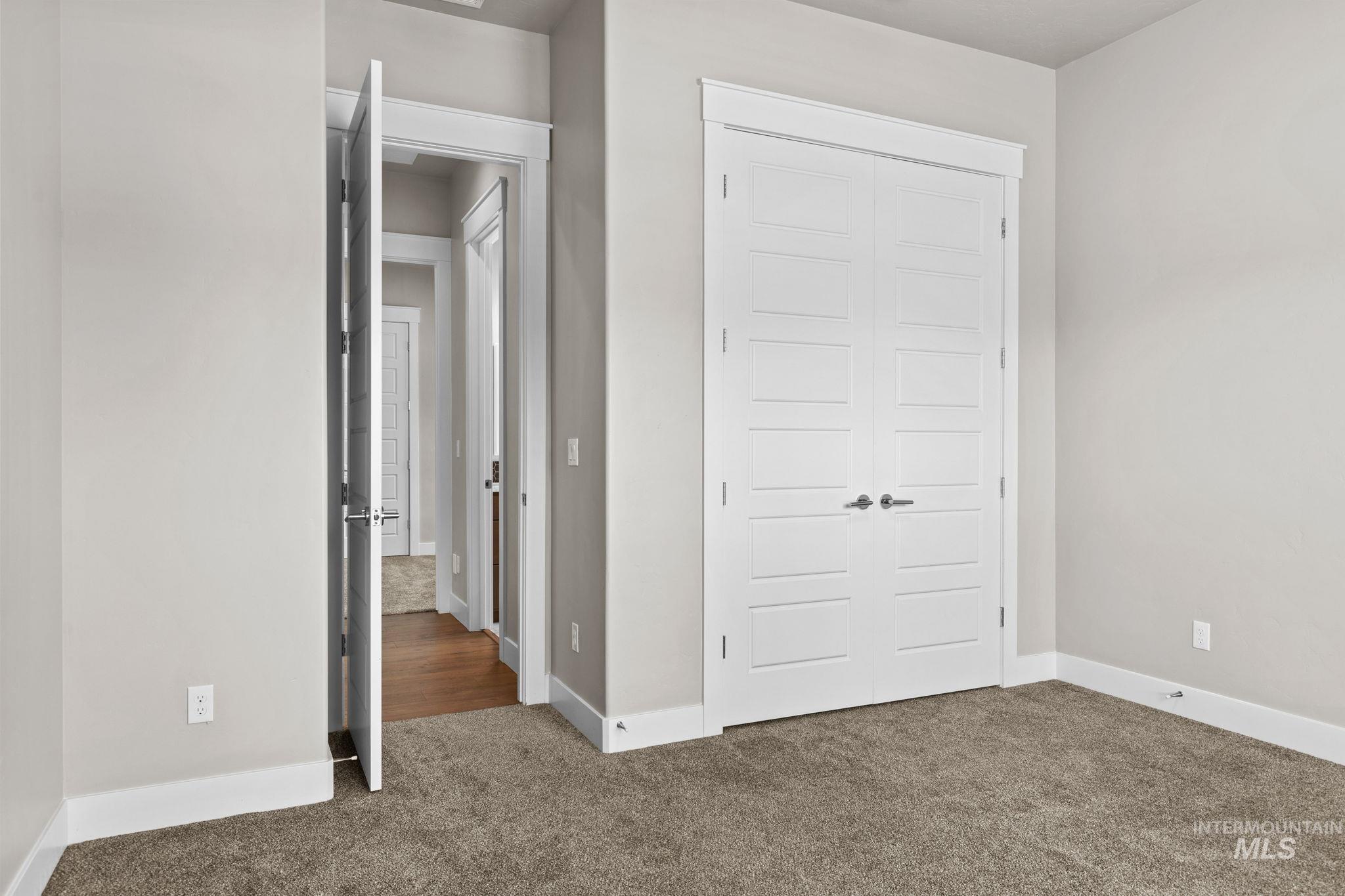 2934 East Murchison Street Meridian, ID 83642 - Photo 29 of 44 Bedroom featuring neutral tone carpeting and light gray wall paint