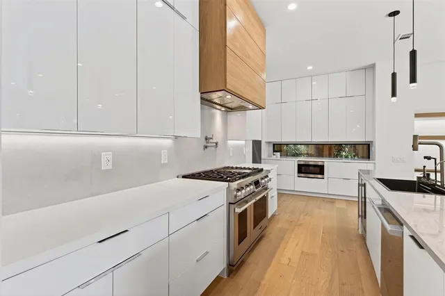 a kitchen with kitchen island a sink stove and wooden floor