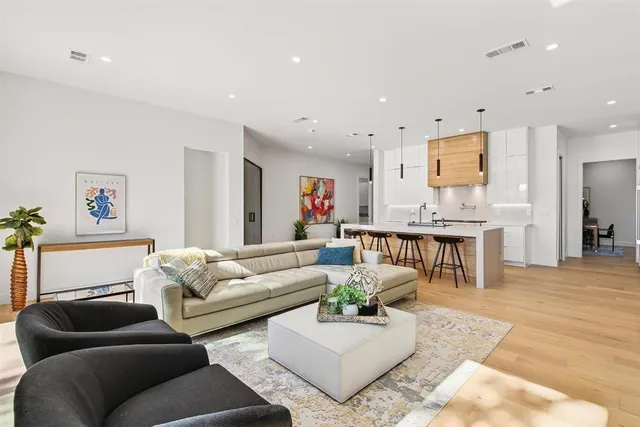 a living room with furniture and a wooden floor