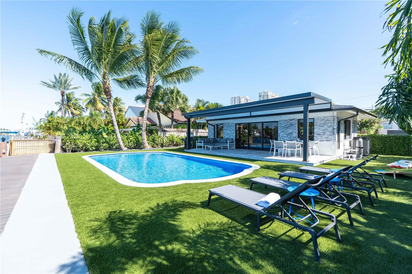 a view of a house with swimming pool and sitting area