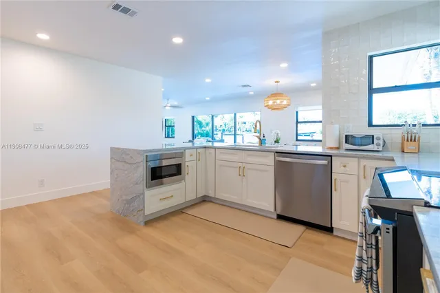 a kitchen with a sink cabinets and window