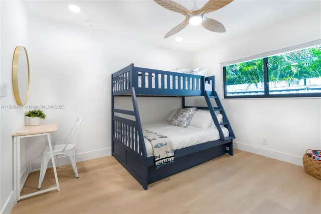 a bed sitting in a bedroom next to a window