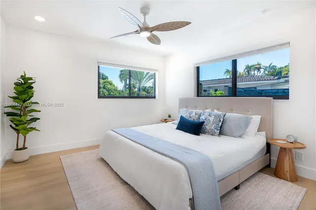 a bedroom with bed and a painting on the wall