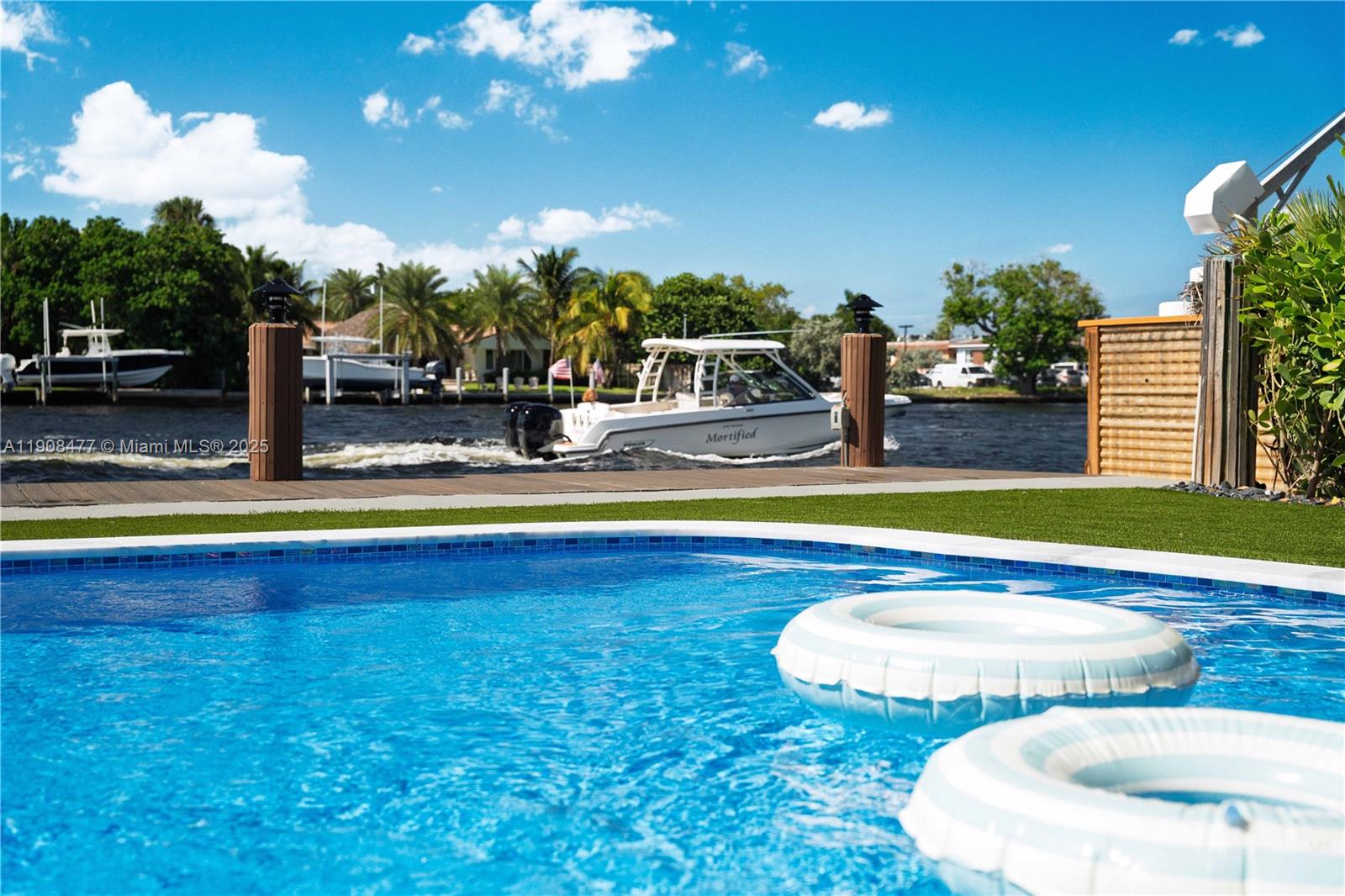 309 South Riverside Drive Pompano Beach, FL 33062 - Photo 3 of 23 a view of a swimming pool with an outdoor seating