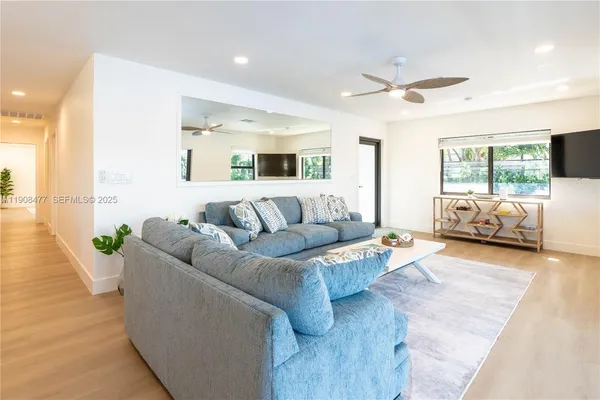 a living room with furniture and a large window
