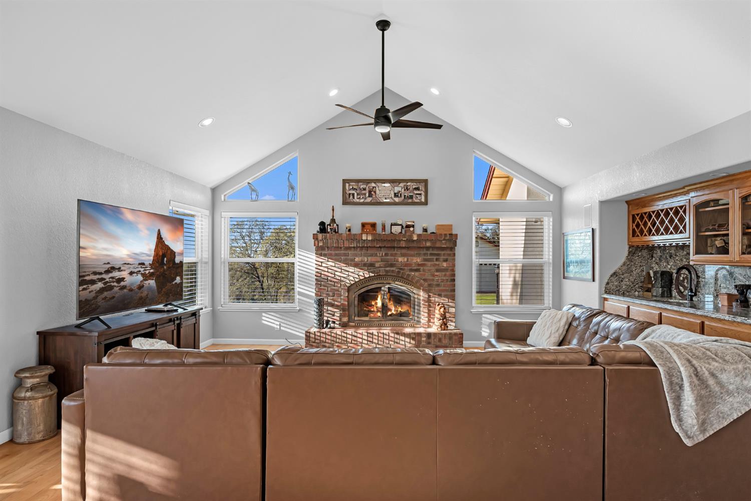 5772 Dragon Springs Road Placerville, CA 95667 - Photo 20 of 85 a living room with furniture a fireplace and a flat screen tv