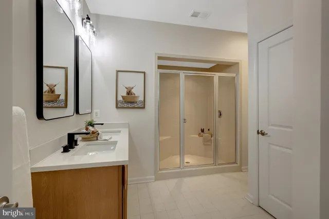 a bathroom with a shower sink and mirror