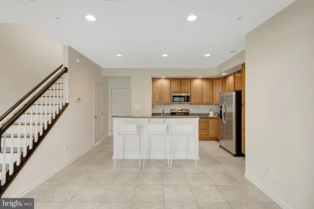 a view of kitchen with furniture and white appliances
