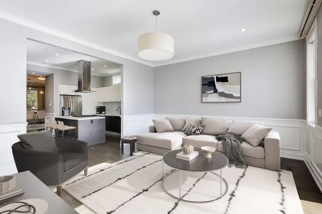 a living room with furniture and a chandelier