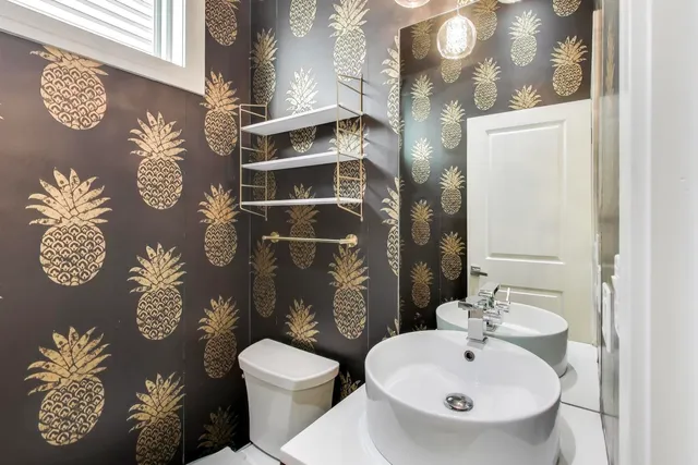 a bathroom with a toilet sink and mirror