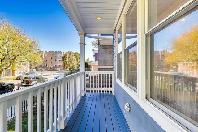 a view of a balcony with wooden floor