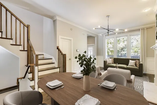 a living room with furniture and a chandelier