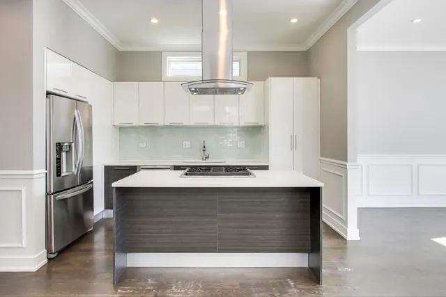 a kitchen with stainless steel appliances granite countertop a stove a refrigerator and a sink