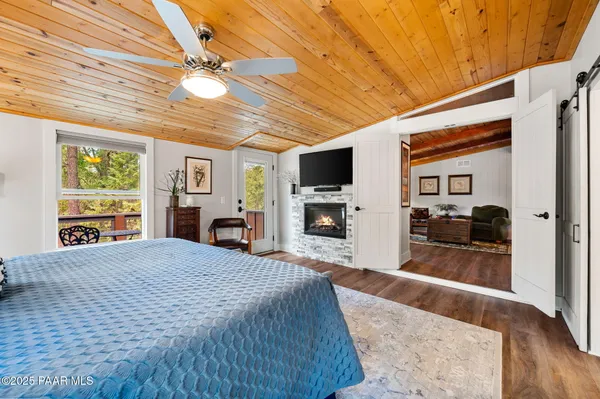 a large bedroom with furniture fireplace and flat screen tv