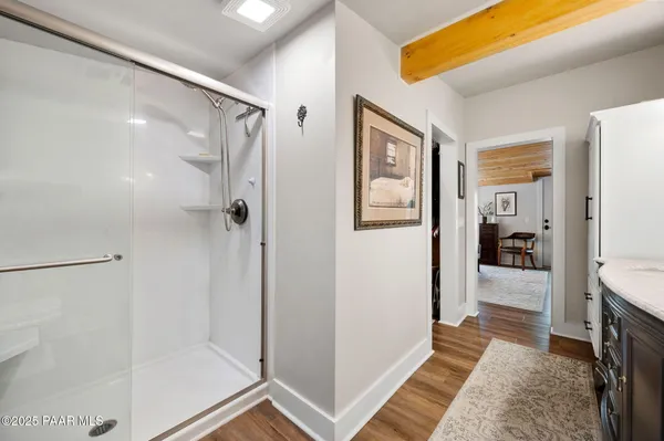 a bathroom with a glass shower door