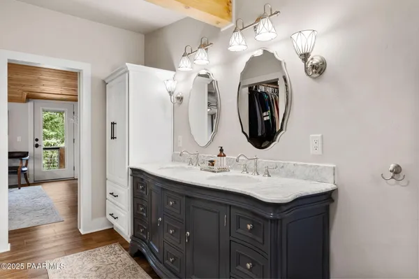 a bathroom with a double vanity sink and a mirror