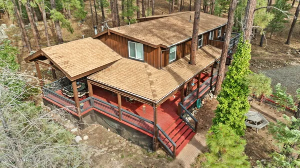 an aerial view of a house with balcony and wooden floor