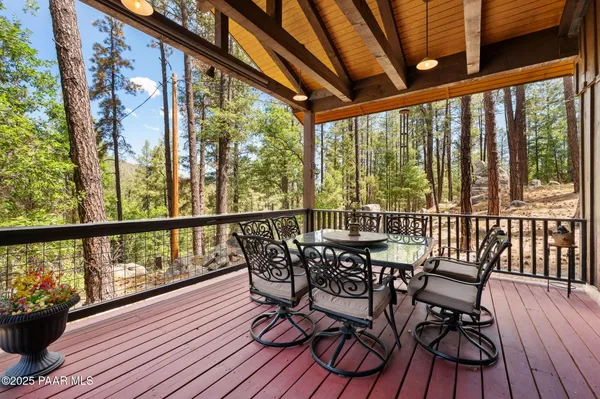 a view of a balcony with furniture and wooden floor