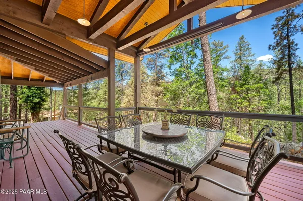 a view of a balcony with chairs and wooden floor