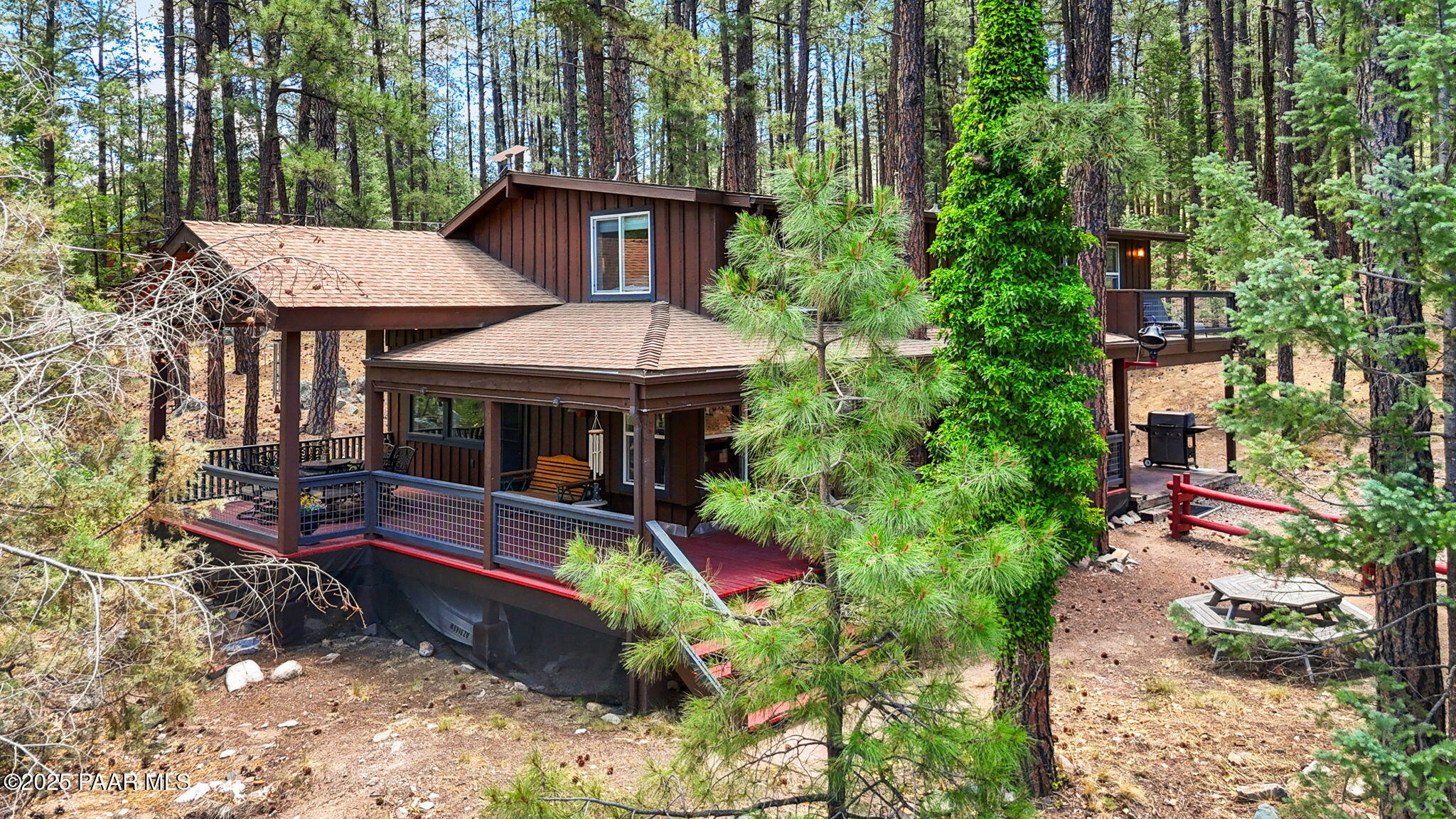 6231 South Champion Way Road Prescott, AZ 86303 - Photo 31 of 43 an aerial view of a house with table and chairs under an umbrella