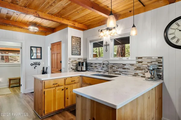 a kitchen with a sink a stove and cabinets