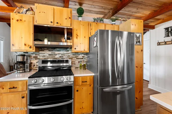 a kitchen with a stove and a refrigerator