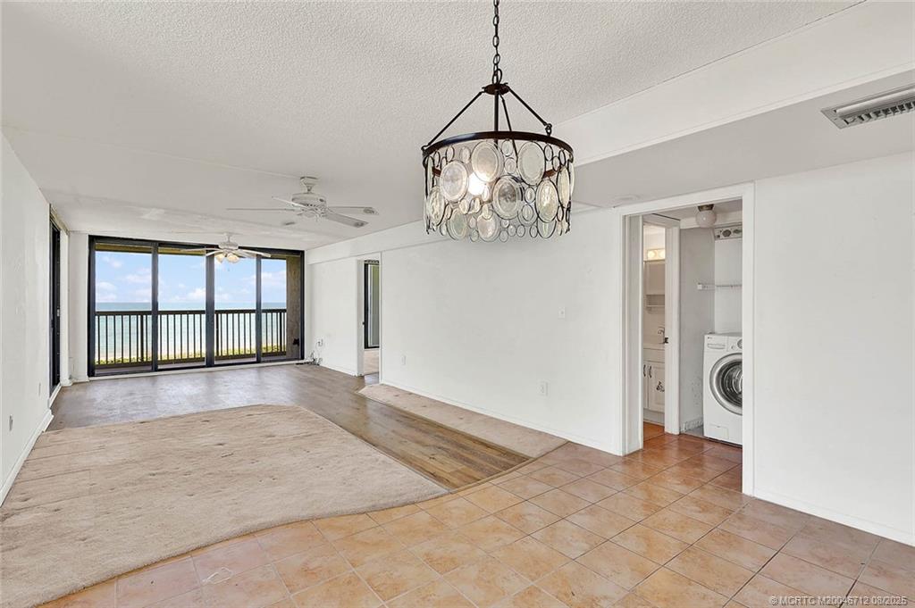 10600 South Ocean Drive, Unit 201 Jensen Beach, FL 34957 - Photo 18 of 40 a view of a room with a large window and chandelier