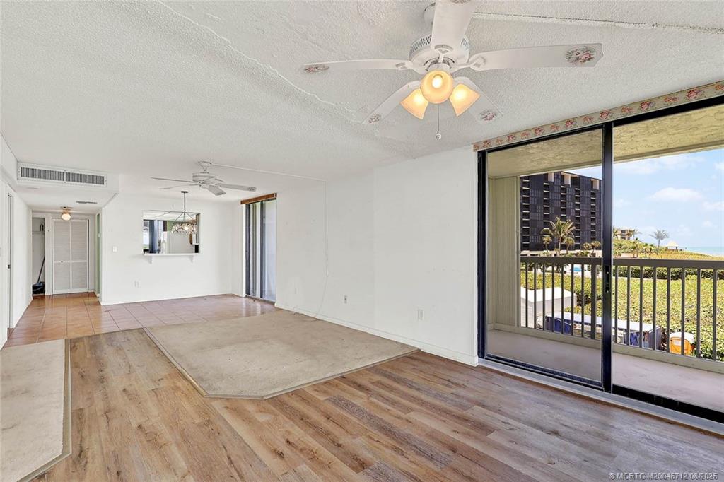 10600 South Ocean Drive, Unit 201 Jensen Beach, FL 34957 - Photo 20 of 40 a view of empty room with wooden floor and fan
