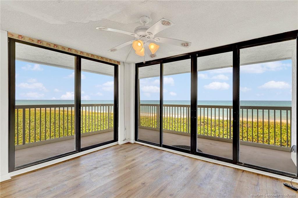 10600 South Ocean Drive, Unit 201 Jensen Beach, FL 34957 - Photo 21 of 40 a view of an empty room with wooden floor and a window