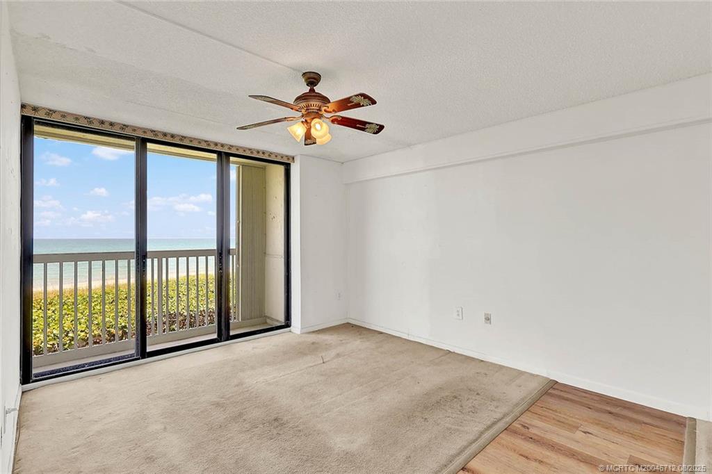 10600 South Ocean Drive, Unit 201 Jensen Beach, FL 34957 - Photo 22 of 40 an empty room with windows and fan