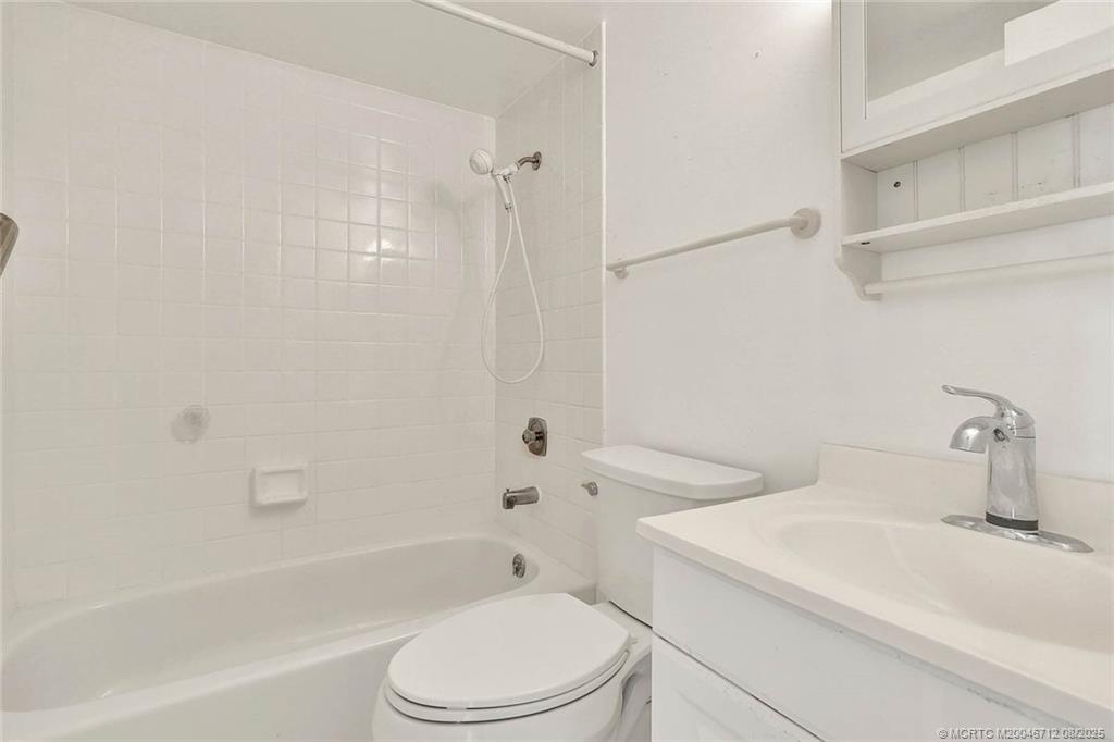 10600 South Ocean Drive, Unit 201 Jensen Beach, FL 34957 - Photo 28 of 40 a bathroom with a sink a toilet and a bathtub