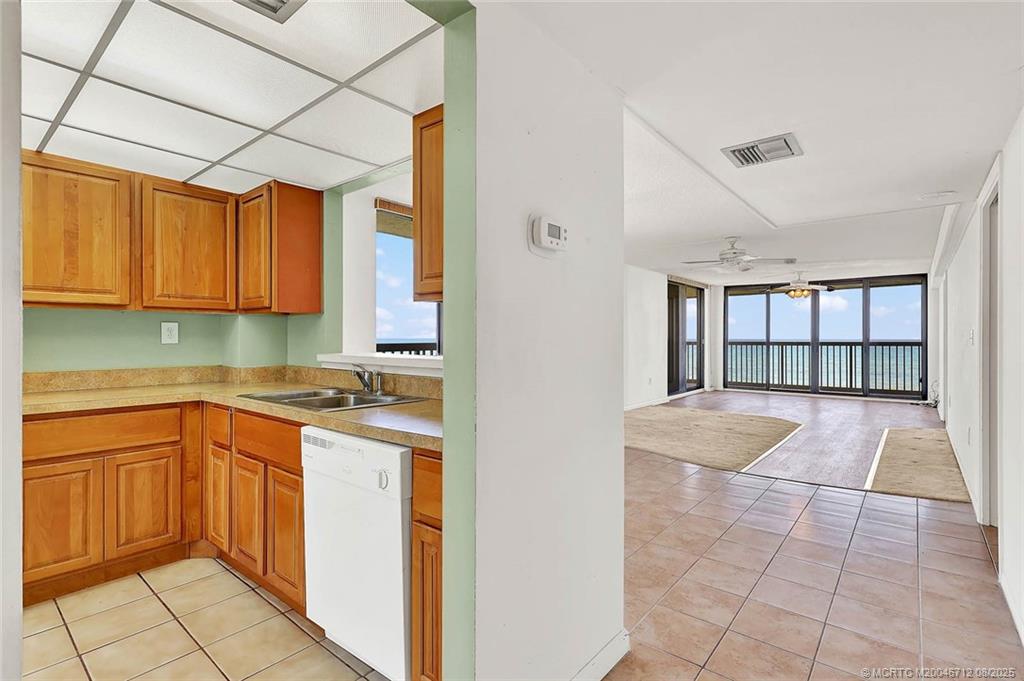 10600 South Ocean Drive, Unit 201 Jensen Beach, FL 34957 - Photo 10 of 40 a kitchen with a sink window and cabinets