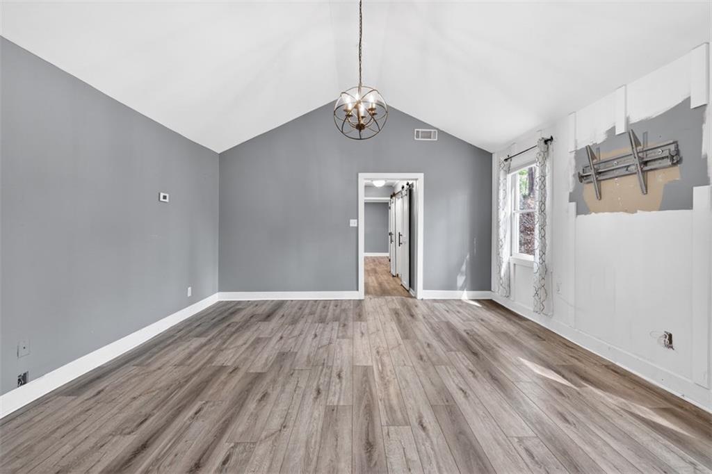 627 Rock Springs Road Lawrenceville, GA 30043 - Photo 21 of 85 a view of an empty room with wooden floor and cabinet