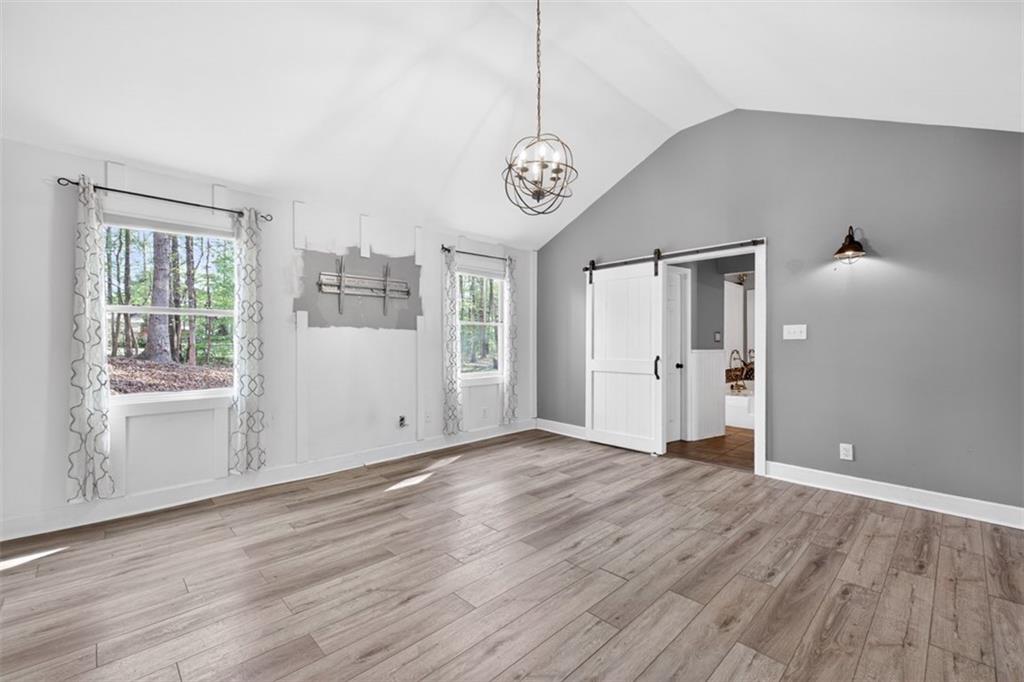 627 Rock Springs Road Lawrenceville, GA 30043 - Photo 22 of 85 a view of an empty room with wooden floor and a window