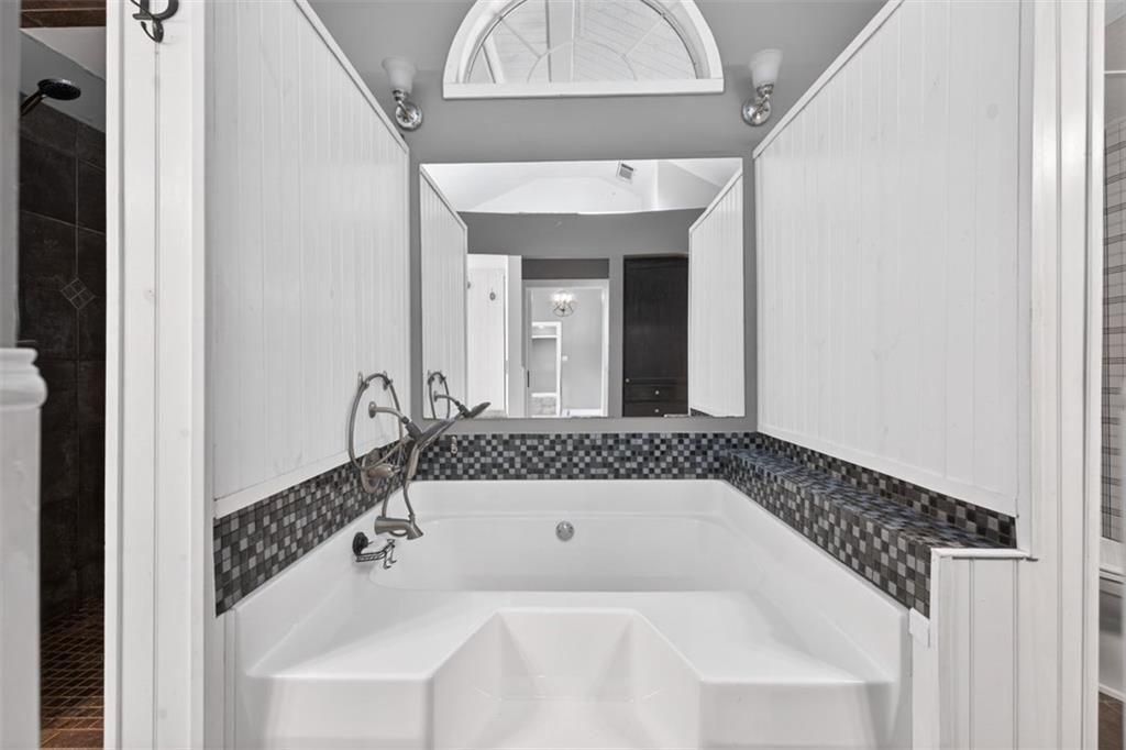 627 Rock Springs Road Lawrenceville, GA 30043 - Photo 24 of 85 a bathroom with a bathtub and a shower