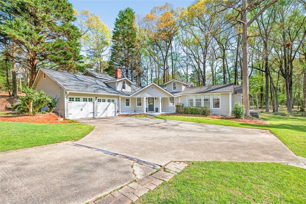 627 Rock Springs Road Lawrenceville, GA 30043 - Photo 3 of 85 a view of a house with a swimming pool and a yard