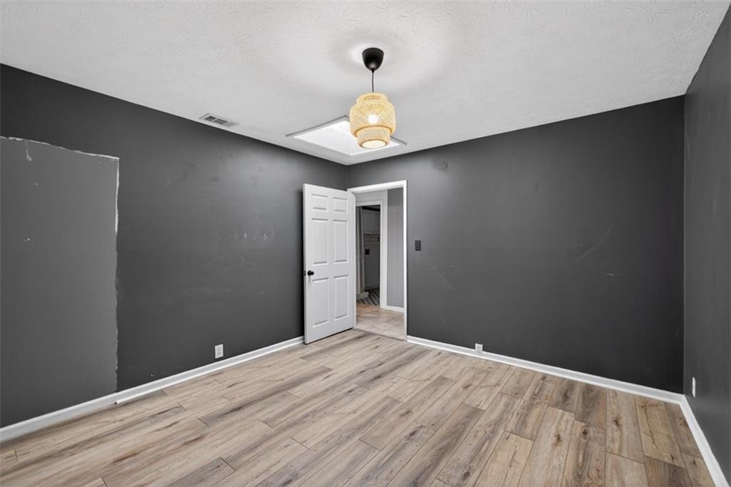 627 Rock Springs Road Lawrenceville, GA 30043 - Photo 35 of 85 a view of a livingroom with wooden floor and a ceiling fan