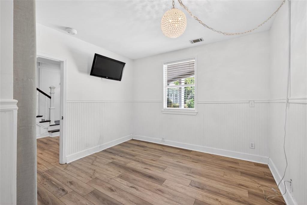 627 Rock Springs Road Lawrenceville, GA 30043 - Photo 42 of 85 a view of empty room with wooden floor and window