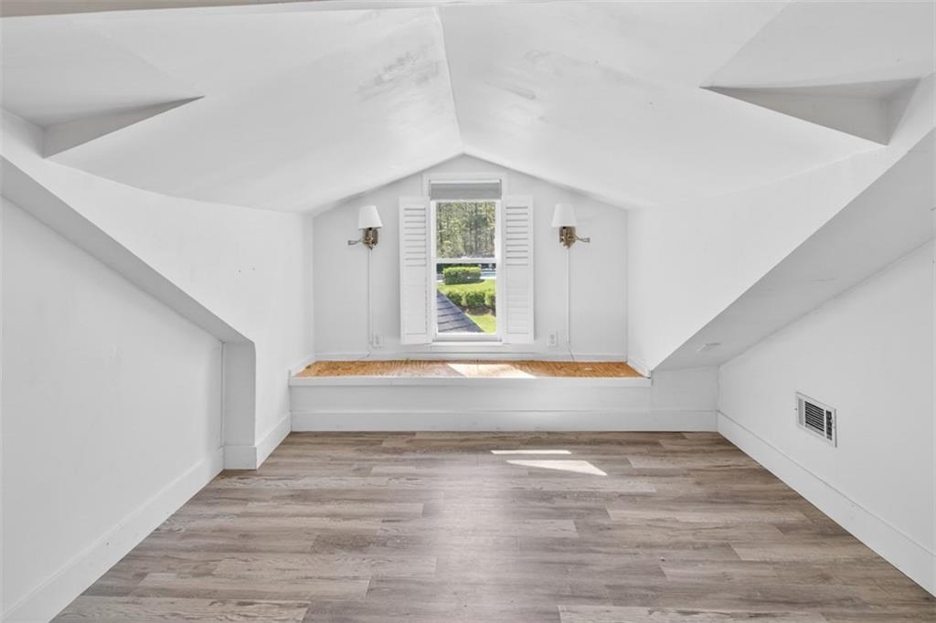 627 Rock Springs Road Lawrenceville, GA 30043 - Photo 47 of 85 a view of an empty room with wooden floor and a window