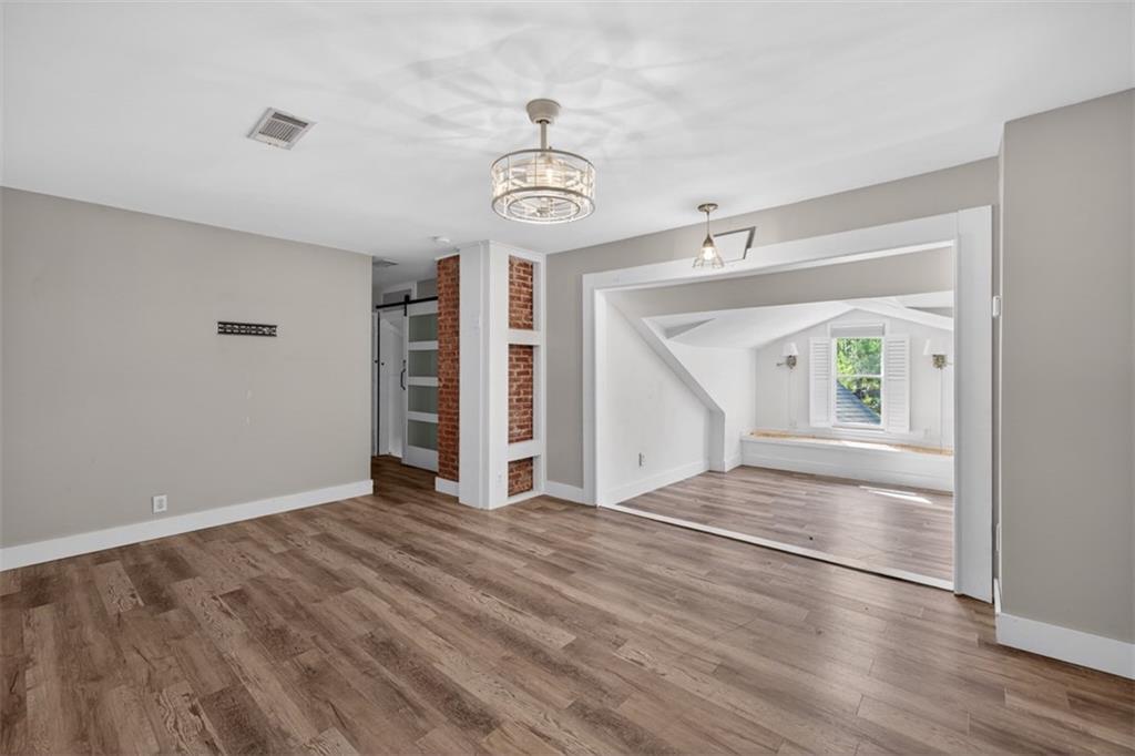 627 Rock Springs Road Lawrenceville, GA 30043 - Photo 48 of 85 a view of an empty room with a window and wooden floor