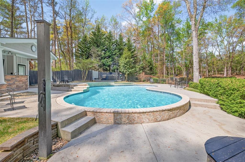 627 Rock Springs Road Lawrenceville, GA 30043 - Photo 60 of 85 a view of a swimming pool with a porch