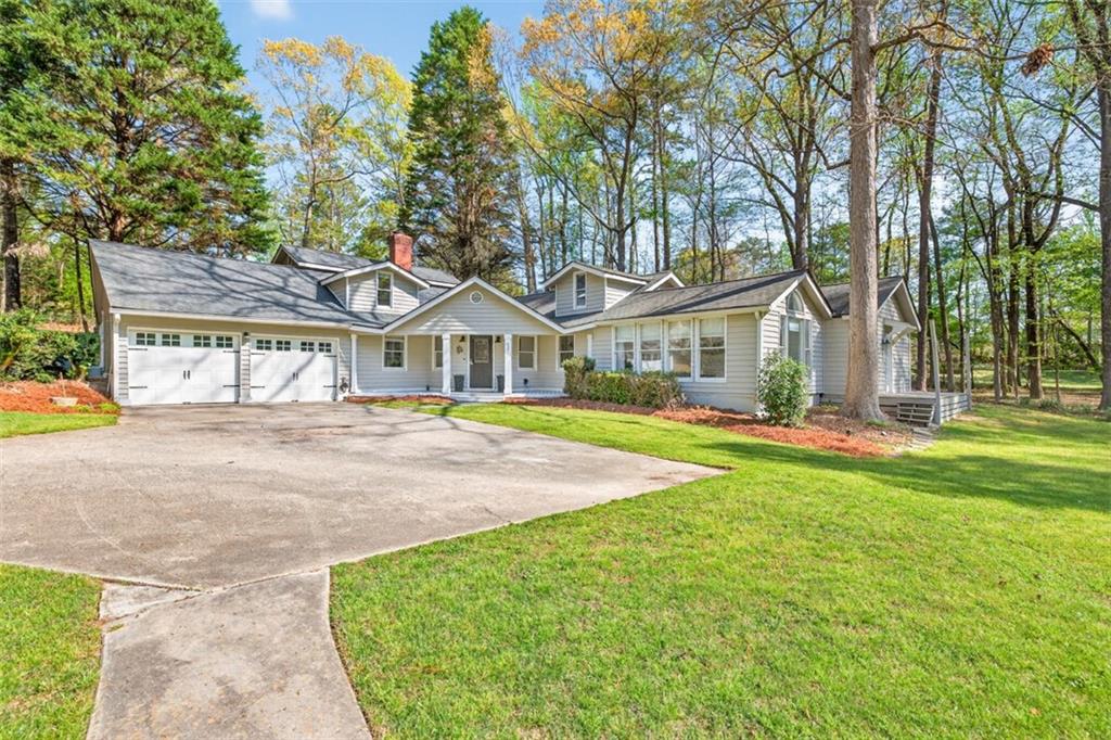 627 Rock Springs Road Lawrenceville, GA 30043 - Photo 6 of 85 a front view of a house with yard and green space