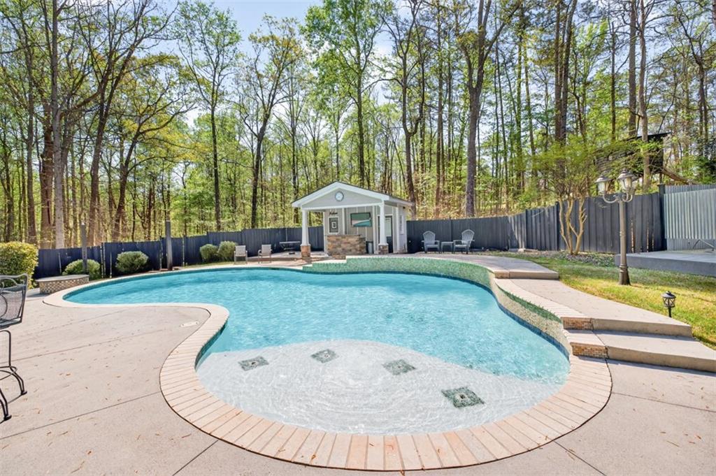 627 Rock Springs Road Lawrenceville, GA 30043 - Photo 64 of 85 a view of a house with swimming pool and a yard