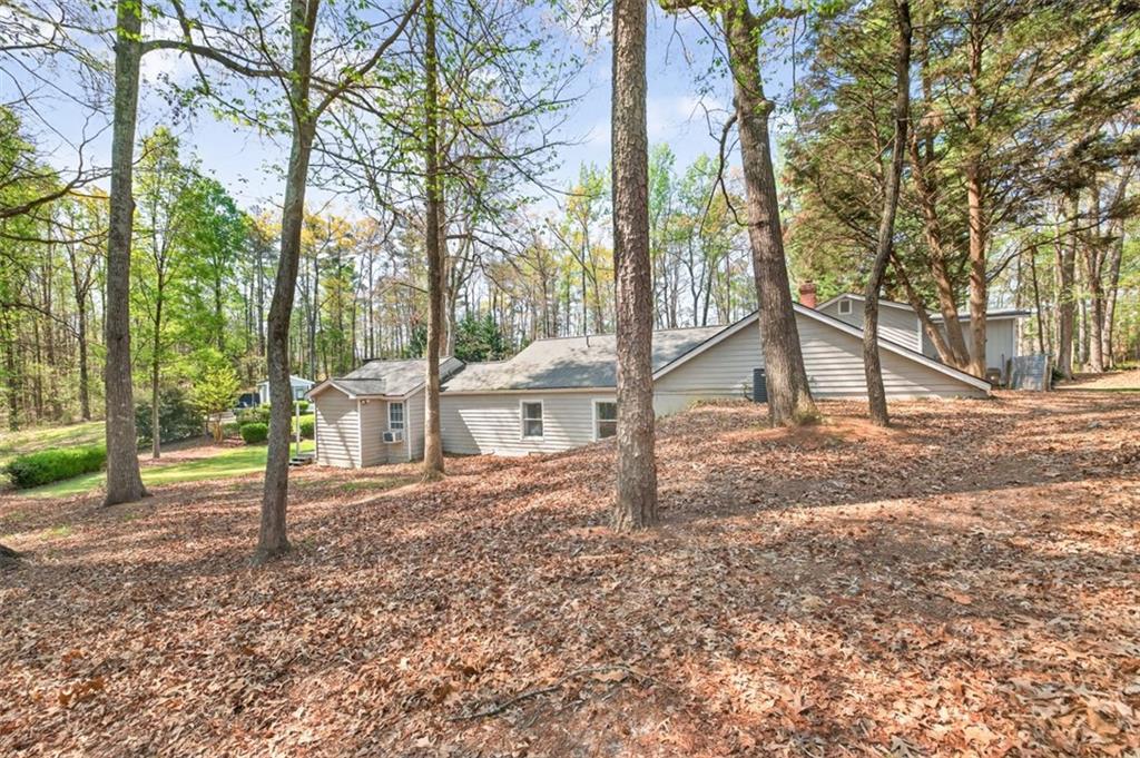 627 Rock Springs Road Lawrenceville, GA 30043 - Photo 69 of 85 a backyard of a house with lots of green space